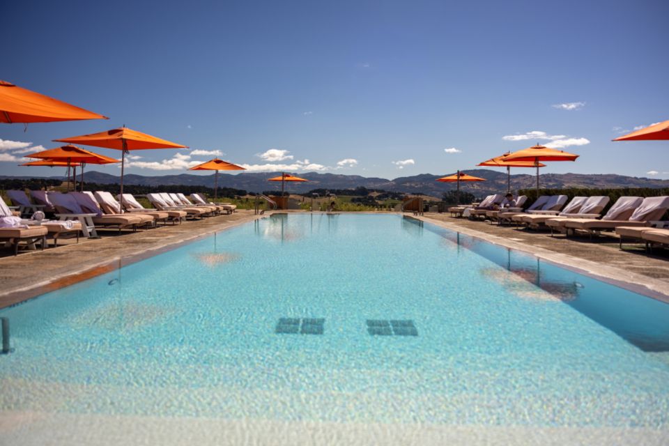 The outdoor swimming pool with loungers alongside