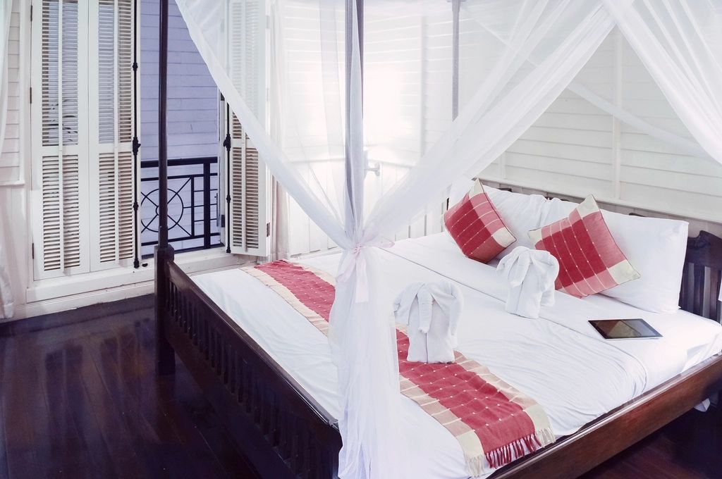 A guest room with a large bed and soft lighting